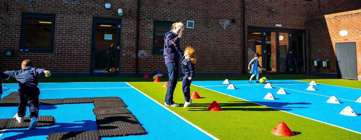 Hurlingham Prep School Putney - Banner of Teacher and Pupil High Five During PE Class