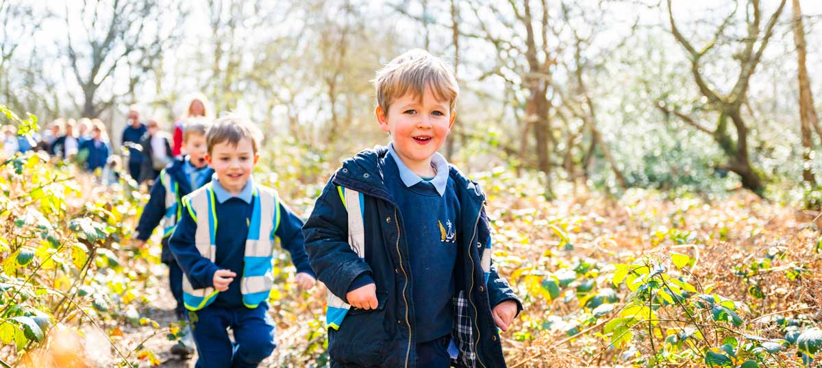 Hurlingham School Nursery - Forest School children on a walk down woodland trail