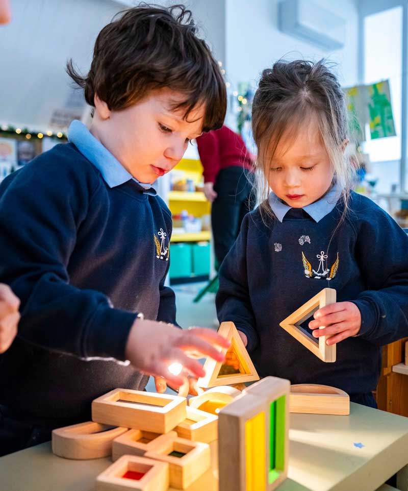 Hurlingham School Nursery - two children playing with coloured montessori blocks